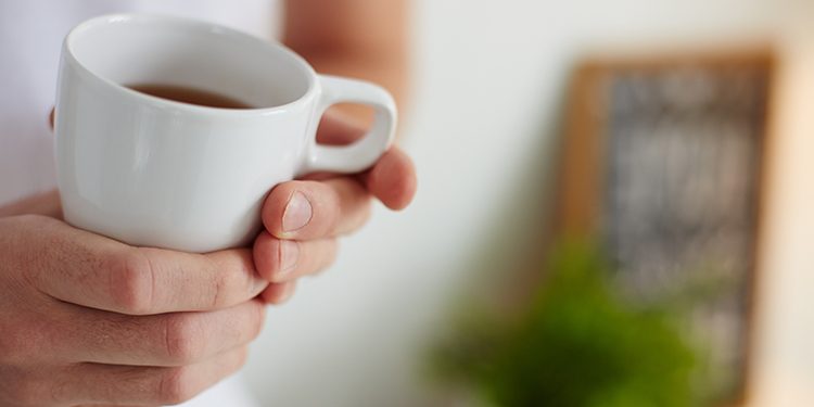Image of cup of tea in male hands
